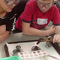 student writing on blackboard